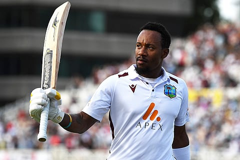 Kavem Hodge walks off after being dismissed by Chris Woakes